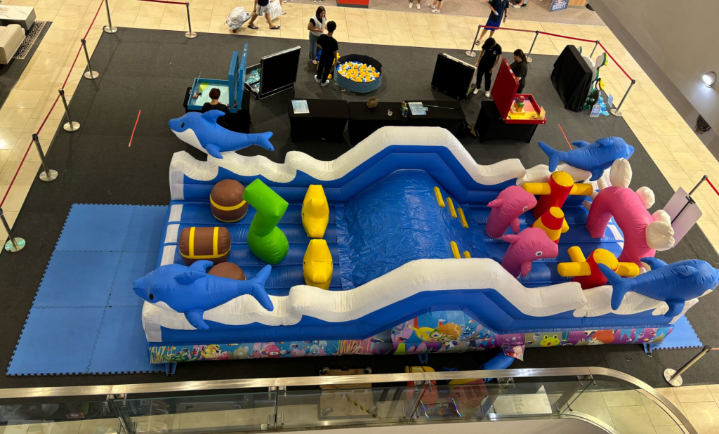 Professional inflatable attractions and obstacle courses setup at Singapore corporate event