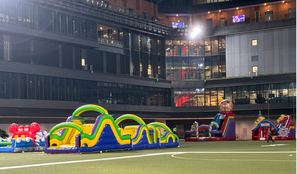 Professional inflatable attractions and obstacle courses setup at Singapore corporate event