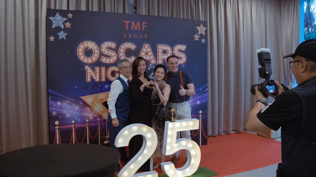 TMF Group's 25th Anniversary Oscar-themed celebration with guests posing at photo wall